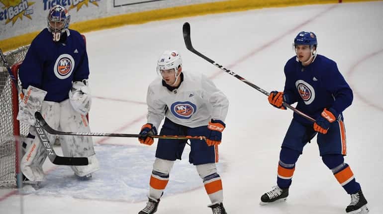 Islanders right wing Oliver Wahlstrom skates in front of defenseman...