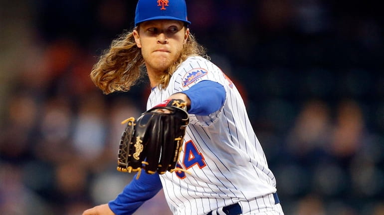 Noah Syndergaard #34 of the New York Mets pitches in...