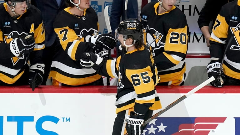 Pittsburgh Penguins' Erik Karlsson (65) returns to the bench after...