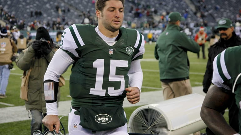 Tim Tebow leaves the field after loss to San Diego...