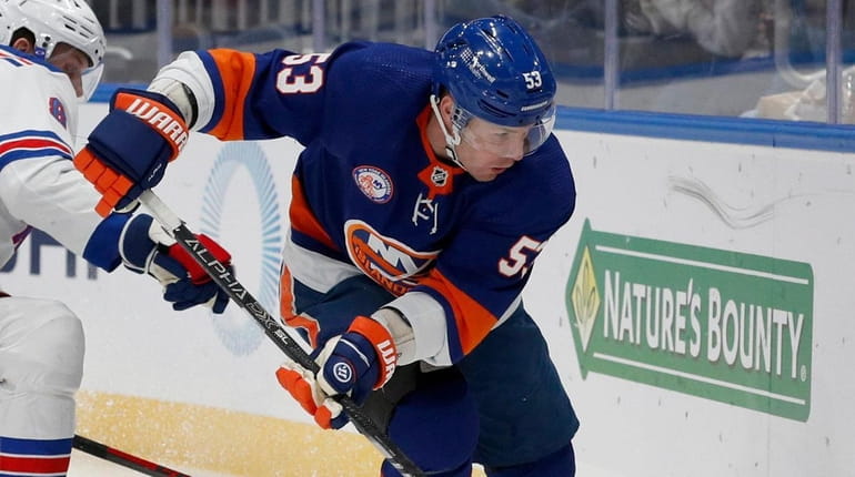 Casey Cizikas #53 of the Islanders plays the puck during...