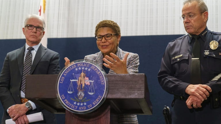 Los Angeles Mayor Karen Bass, center, flanked by District Attorney...