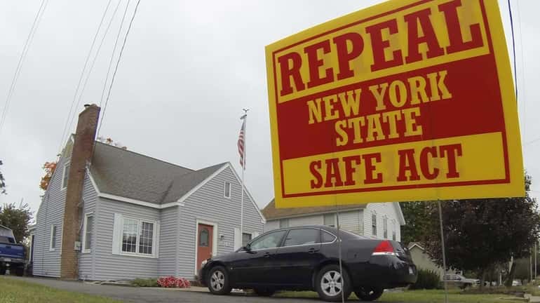 An election campaign yard sign against the New York Safe...