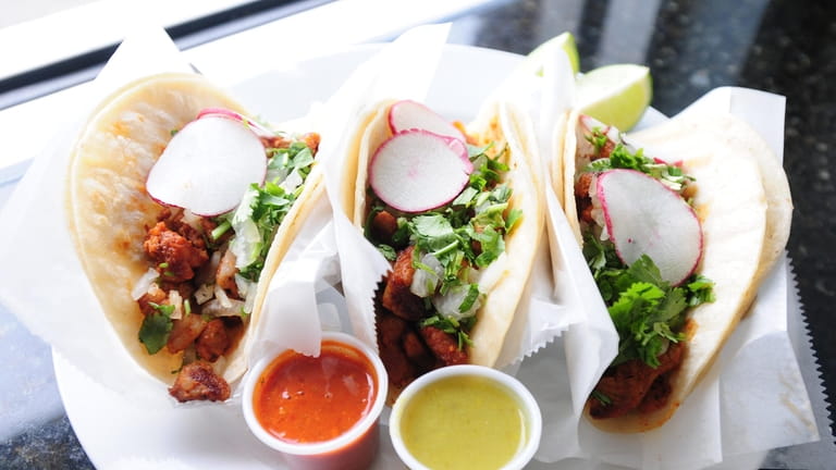 A trio of carnitas tacos at El Paso Authentic Taco...