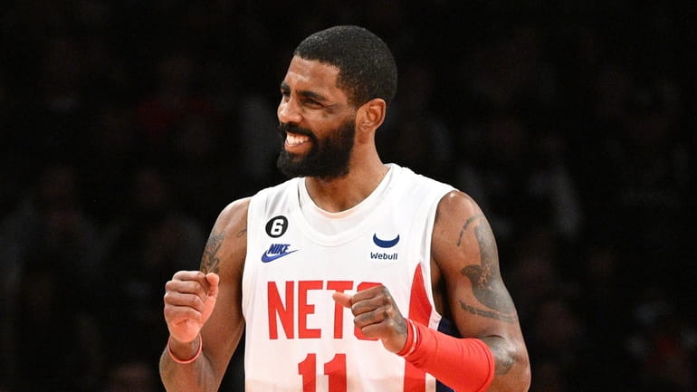 Nets guard Kyrie Irving reacts in the first half of...