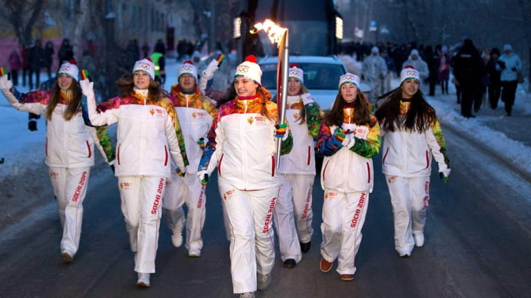 A torchbearer participating in the Sochi 2014 Winter Olympic torch...