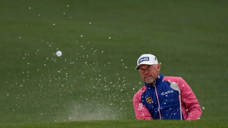 Lee Westwood, of England, hits out of a bunker on...