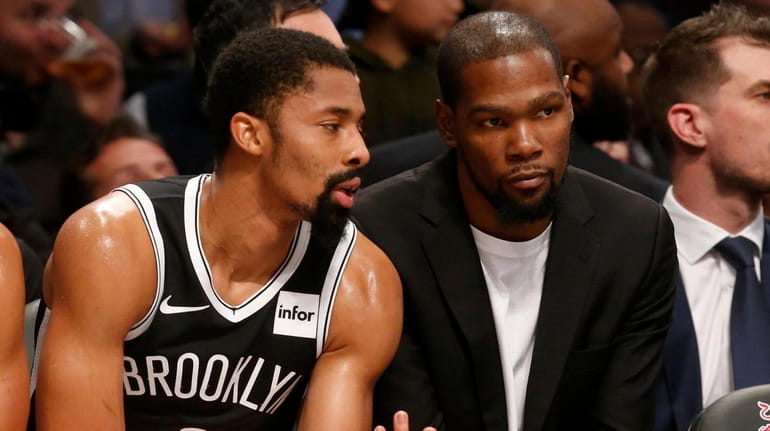 Kevin Durant (right) and Spencer Dinwiddie of the Nets talk...