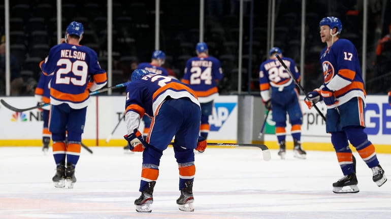 The Islanders leave the ice after losing against Game 3 of...