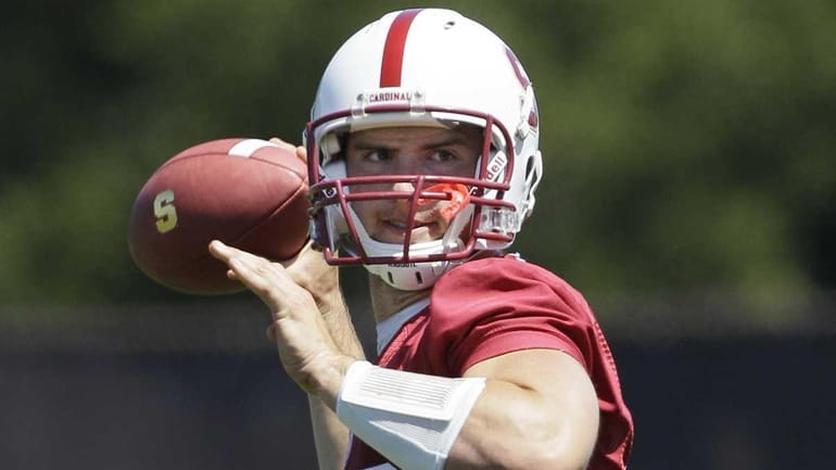 Stanford quarterback Andrew Luck passes during NCAA college football practice...
