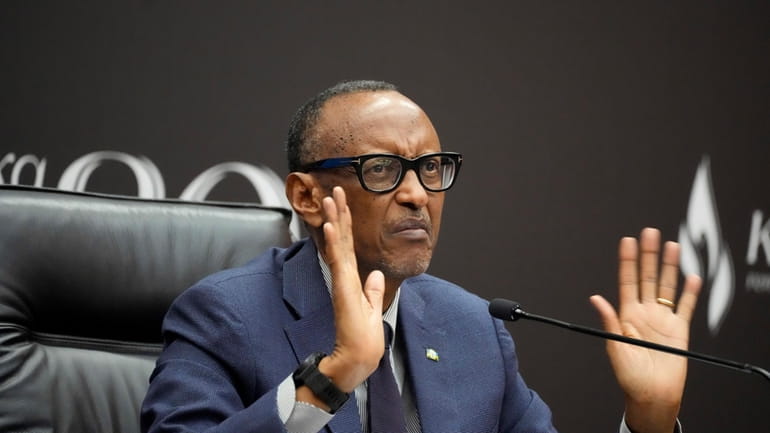 Rwanda's President Paul Kagame gestures as he gives a press...