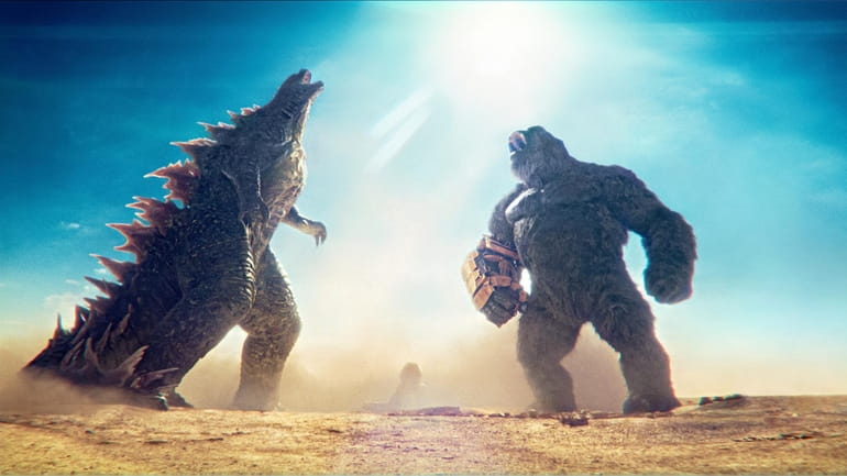 This image released by Warner Bros. Pictures shows Godzilla, left,...