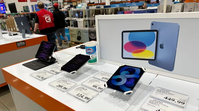 Apple iPads are displayed in a Costco warehouse Sunday, March...