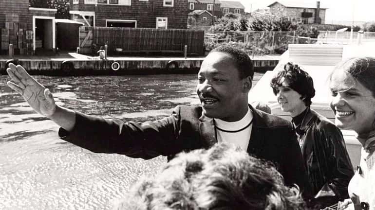 The Rev. Martin Luther King Jr. greets people who came...