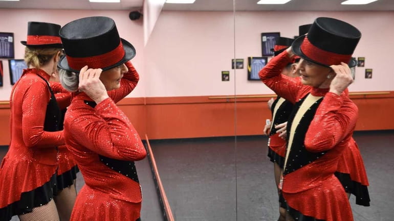 Dancer Susie Fairchild looks in a mirror as she gets...