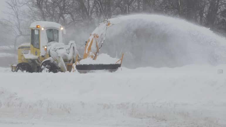 A snowblower clears away snow from an eastbound lane of...