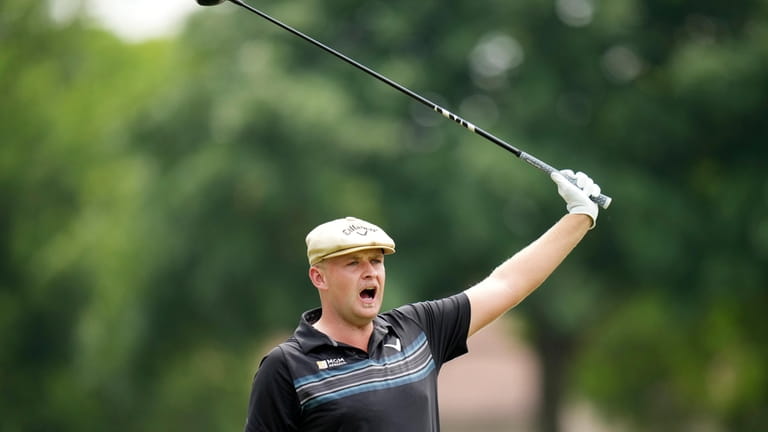 Harry Hall, of England, yells fore after his tee shot...