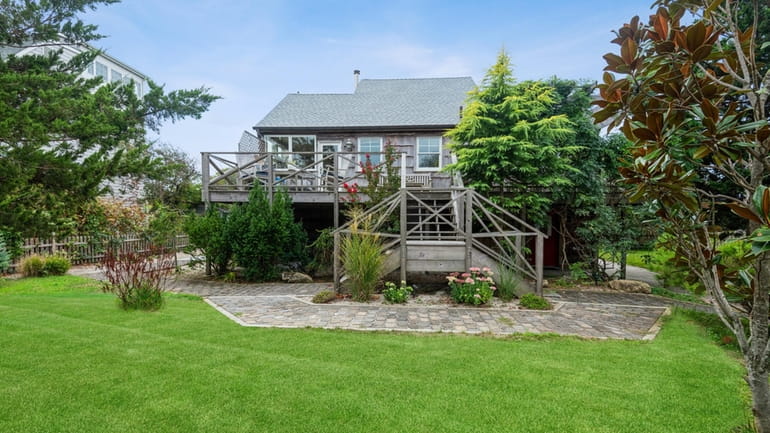 The five-bedroom, 2½-bath cedar frame house comes with access to a...