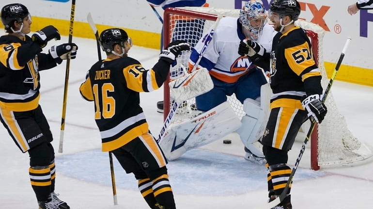 Pittsburgh Penguins' Anthony Angello (57) celebrates with Jason Zucker (16)...