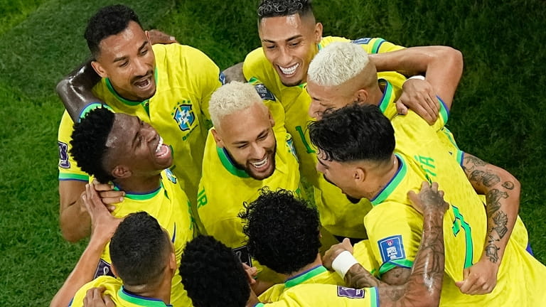 Teammates celebrate with Brazil's Neymar, center, who scored his side's...