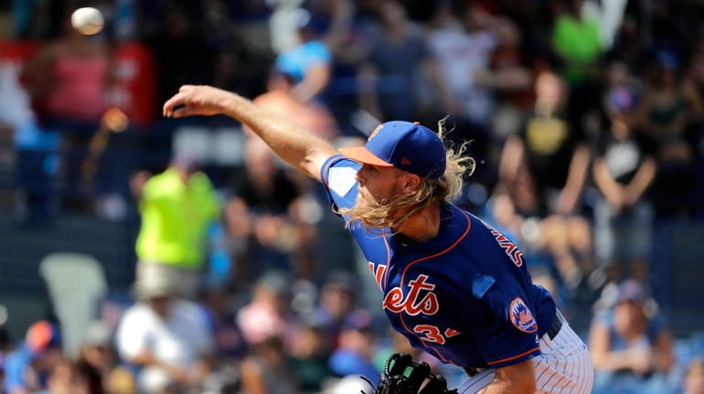 Noah Syndergaard throws during the first inning of the Mets' exhibition...