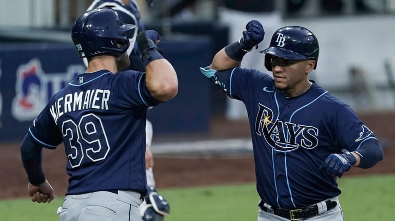 The Rays' Kevin Kiermaier, left, celebrates with Michael Perez after...