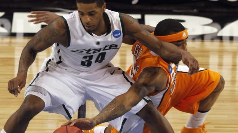 Michigan State's Korie Lucious and Tennessee's Melvin Goins go for...