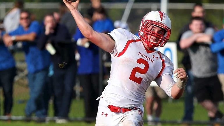 East Islip QB Jack Hannigan looks to pass in a...