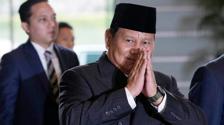 Indonesian President-elect and current Defense Minister Prabowo Subianto greets journalists...