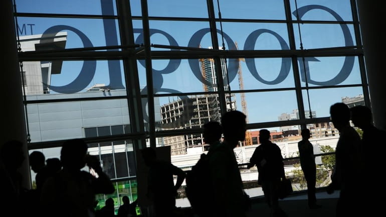 A Google logo is seen through the windows of Moscone...