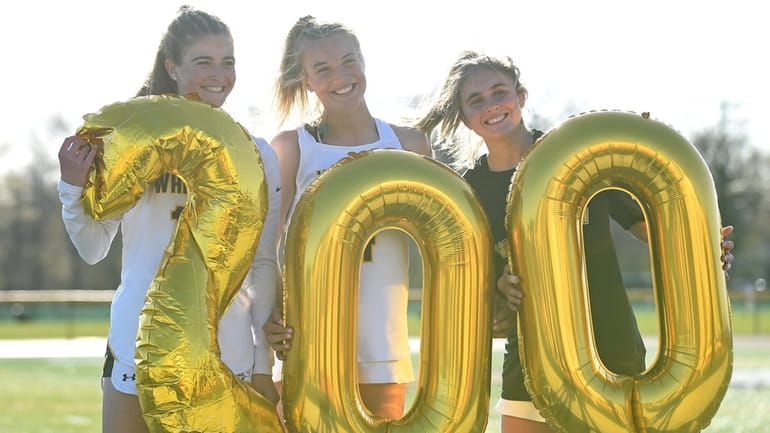 Madison Taylor #4 of Wantagh, center, celebrates her 200th varsity...