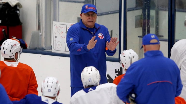 Islanders head coach Barry Trotz addresses the team during training...