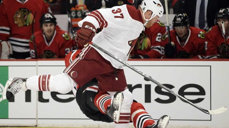 Chicago Blackhawks' Marian Hossa falls down after taking a hit...