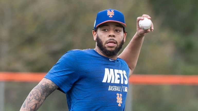 Mets' Dominic Smith throws during a spring training workout, Monday...