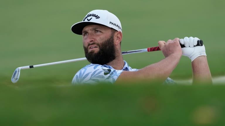 Jon Rahm from Spain plays a bunker shot on the...