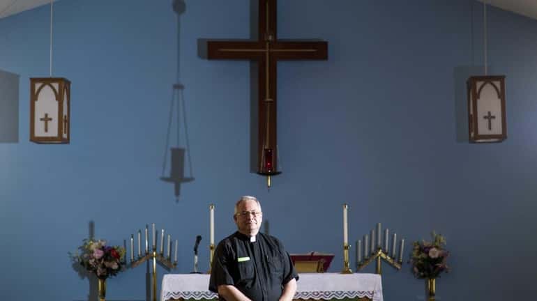 Rev. Dennis Walker, of the Holy Cross Lutherian Church in...