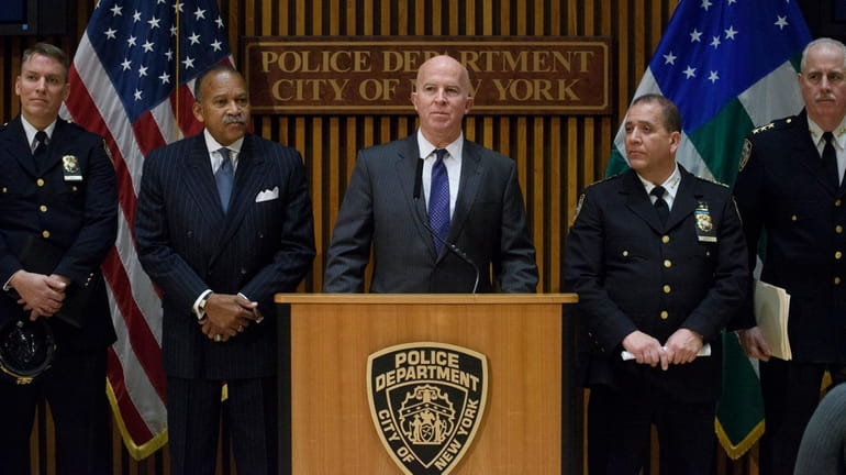 New York City Police Commissioner James O'Neill, center, holds a...