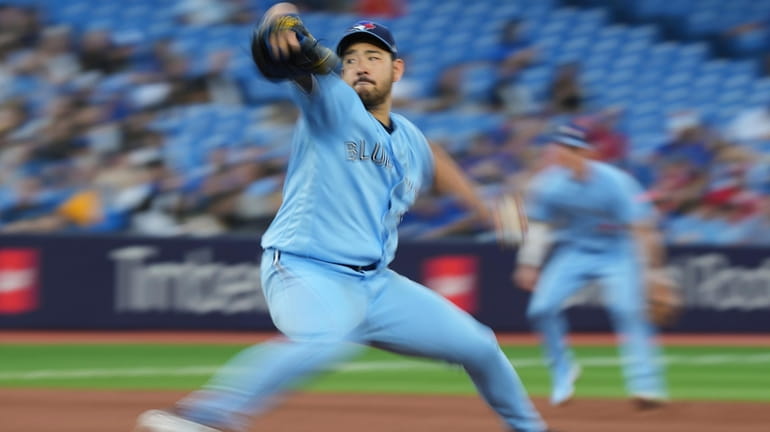 Toronto Blue Jays starting pitcher Yusei Kikuchi throws to a...