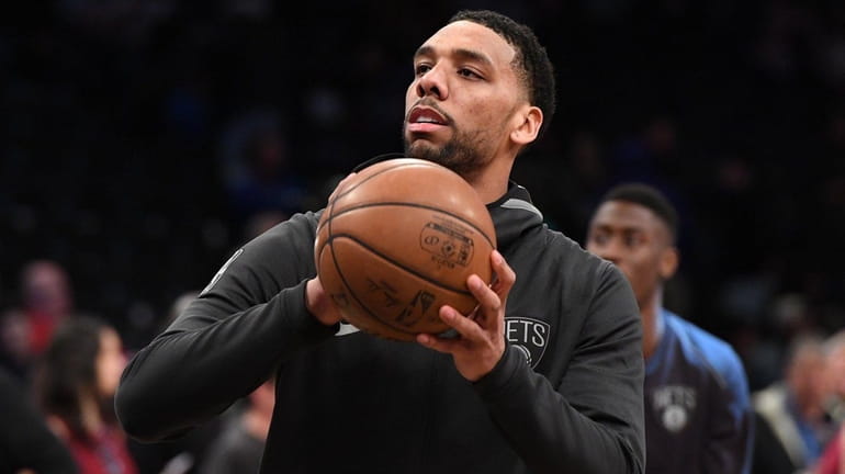 Nets center Jahlil Okafor warms up before a game against...
