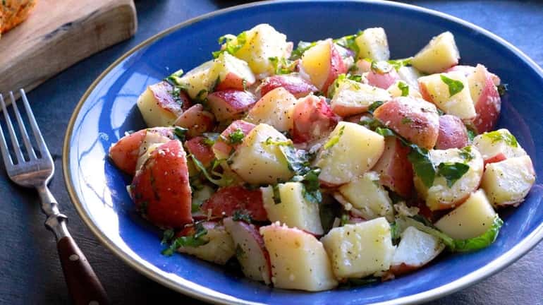 Red potatoes are boiled and tossed with a Caesar-style dressing...