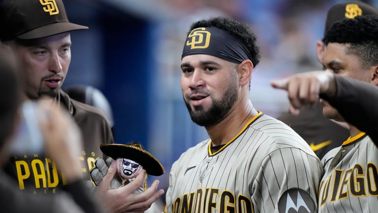 San Diego Padres' Gary Sanchez, center, poses with a ball...