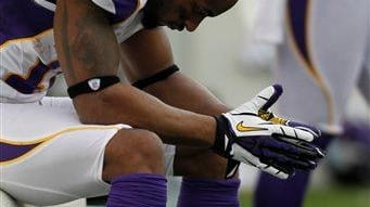 Minnesota Vikings wide receiver Percy Harvin sits on the bench...