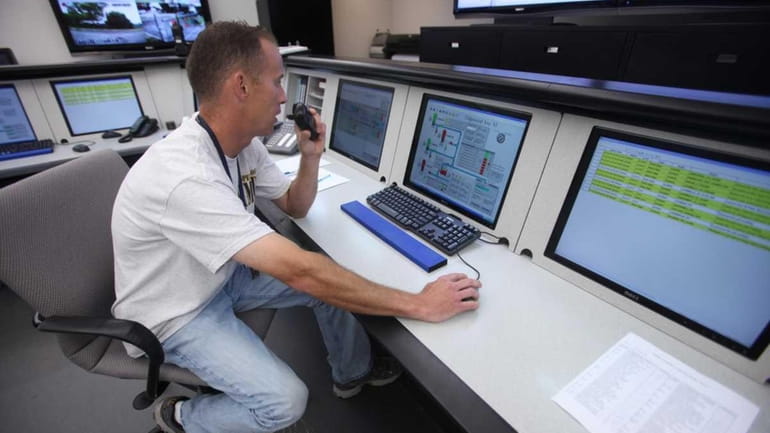 Tim McKell, a control center operator, monitors water pressure and...