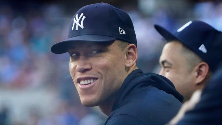 Yankees' Aaron Judge sits in the dugout during a baseball...