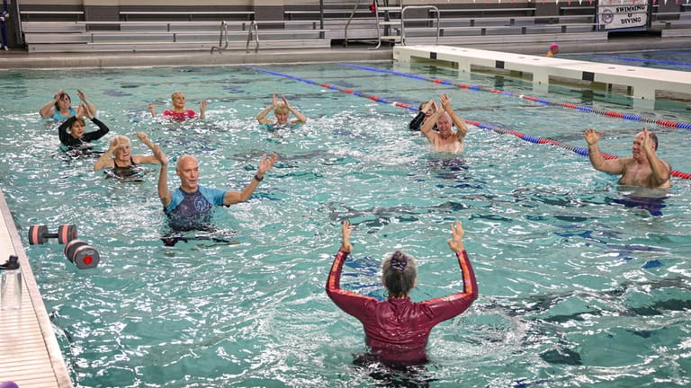 Instructor Bonnie Wong leads a water aerobics class at Michael...