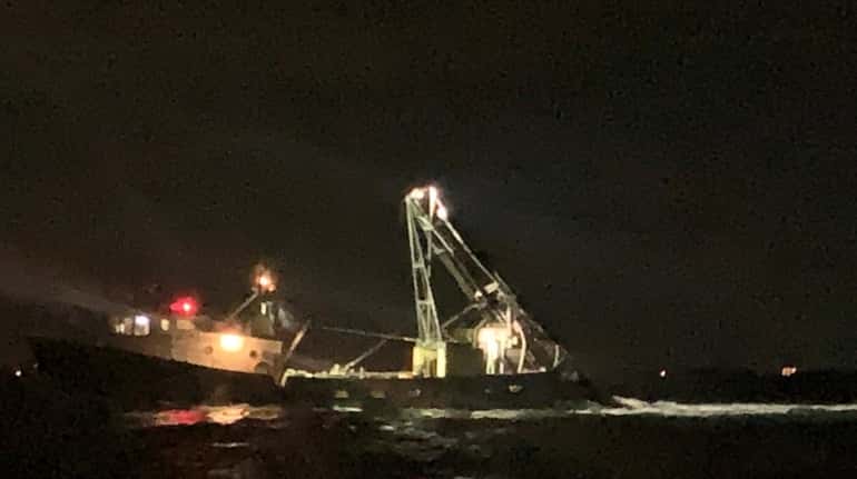 Suffolk County Police Marine Bureau officers rescue the captain of a 77-foot...