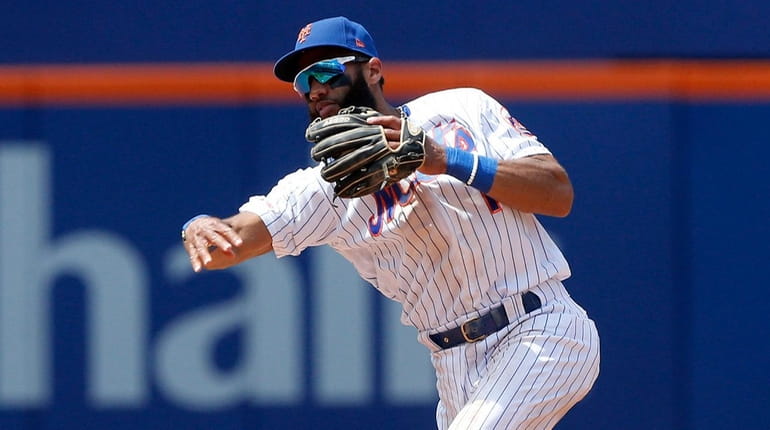 Amed Rosario of the Mets throws for an out during the...