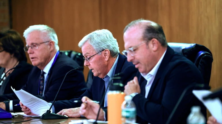 Nassau Temporary Redistricting Commission Chairman Frank Moroney, center, speaks at...