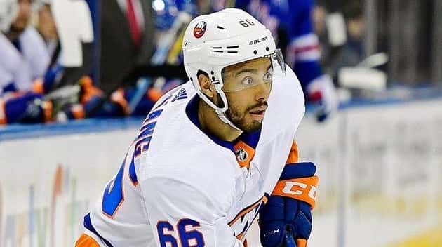 The Islanders' Josh Ho-Sang controls the puck against the Rangers...