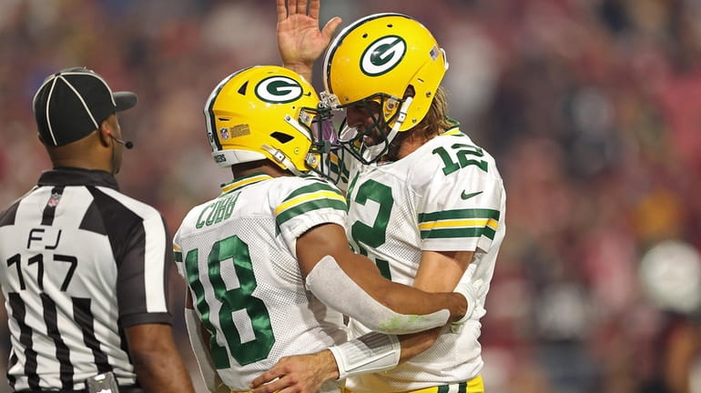 Randall Cobb of the Packers is congratulated by Aaron Rodgers following...